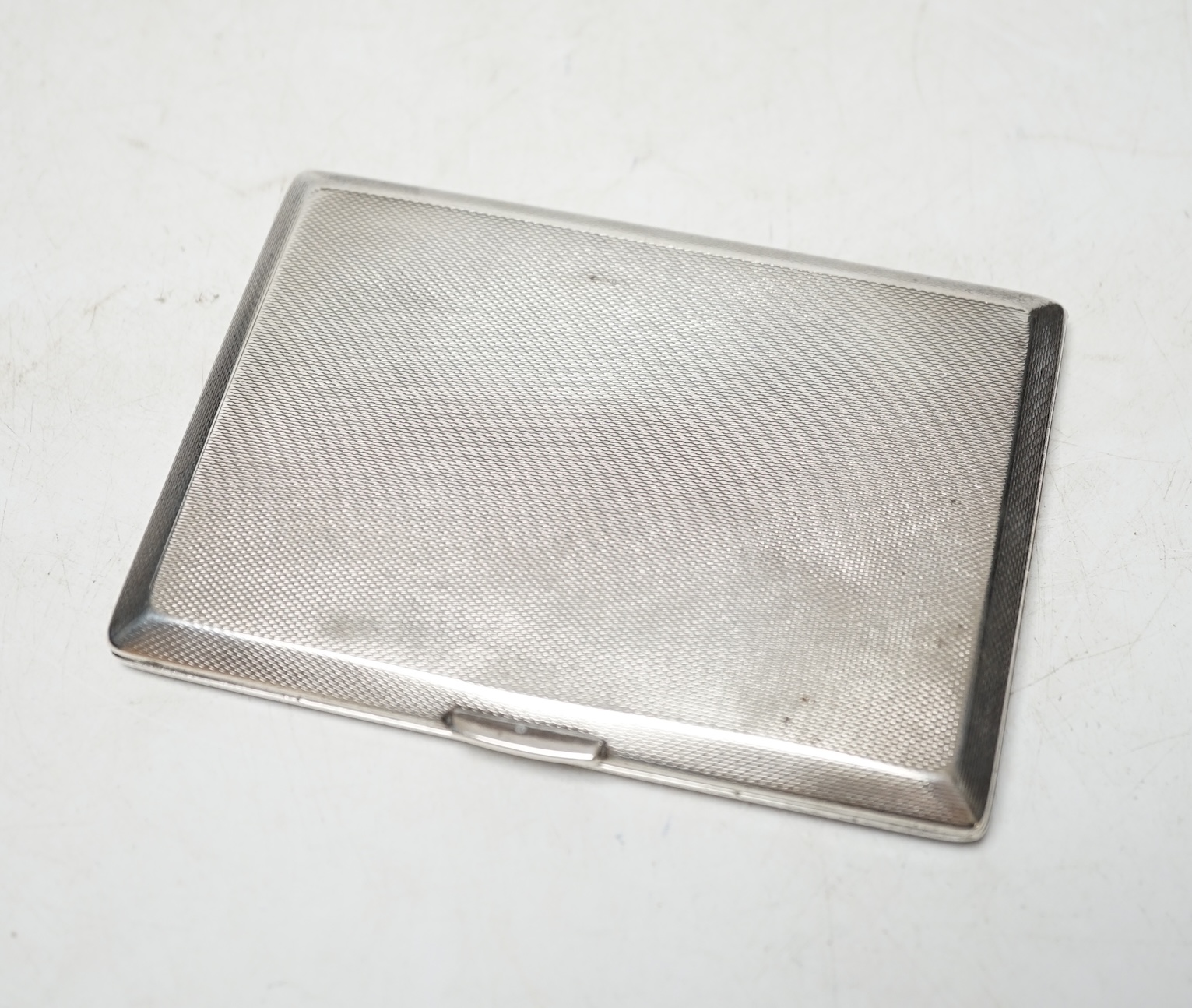 A George VI engine turned silver cigarette case, Birmingham, 1948, 11.6cm. Condition - fair